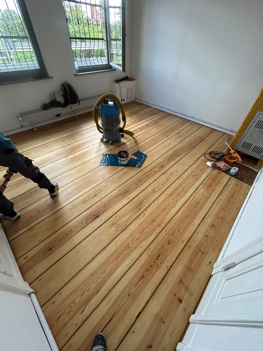 Freshly sanded floorboards during sealing