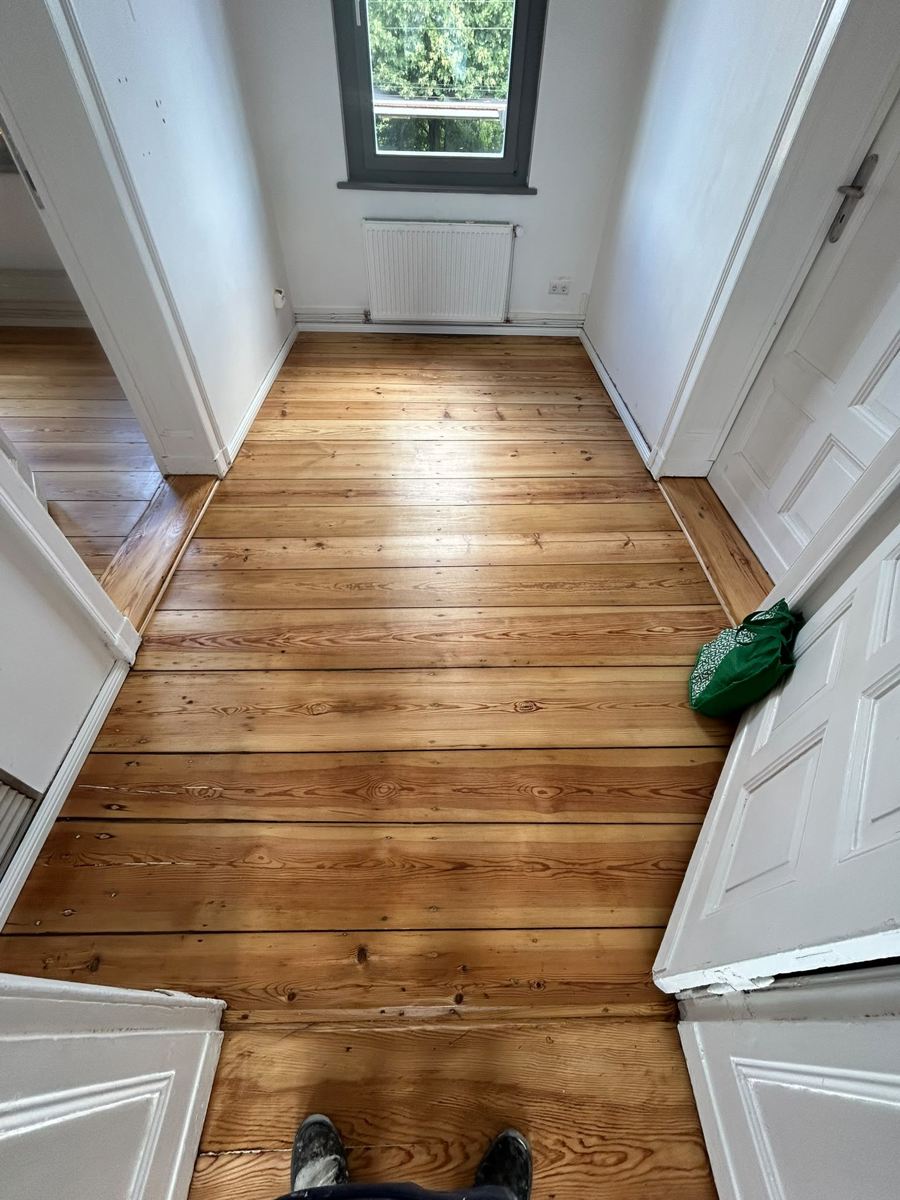Finished sealed pine floorboards in a small room