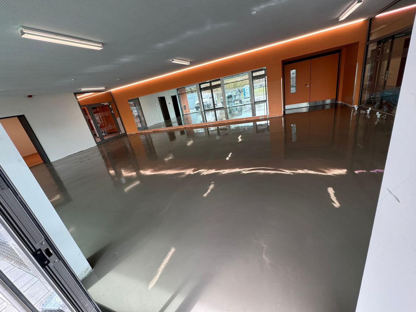 Freshly applied levelling compound in a school room before linoleum installation