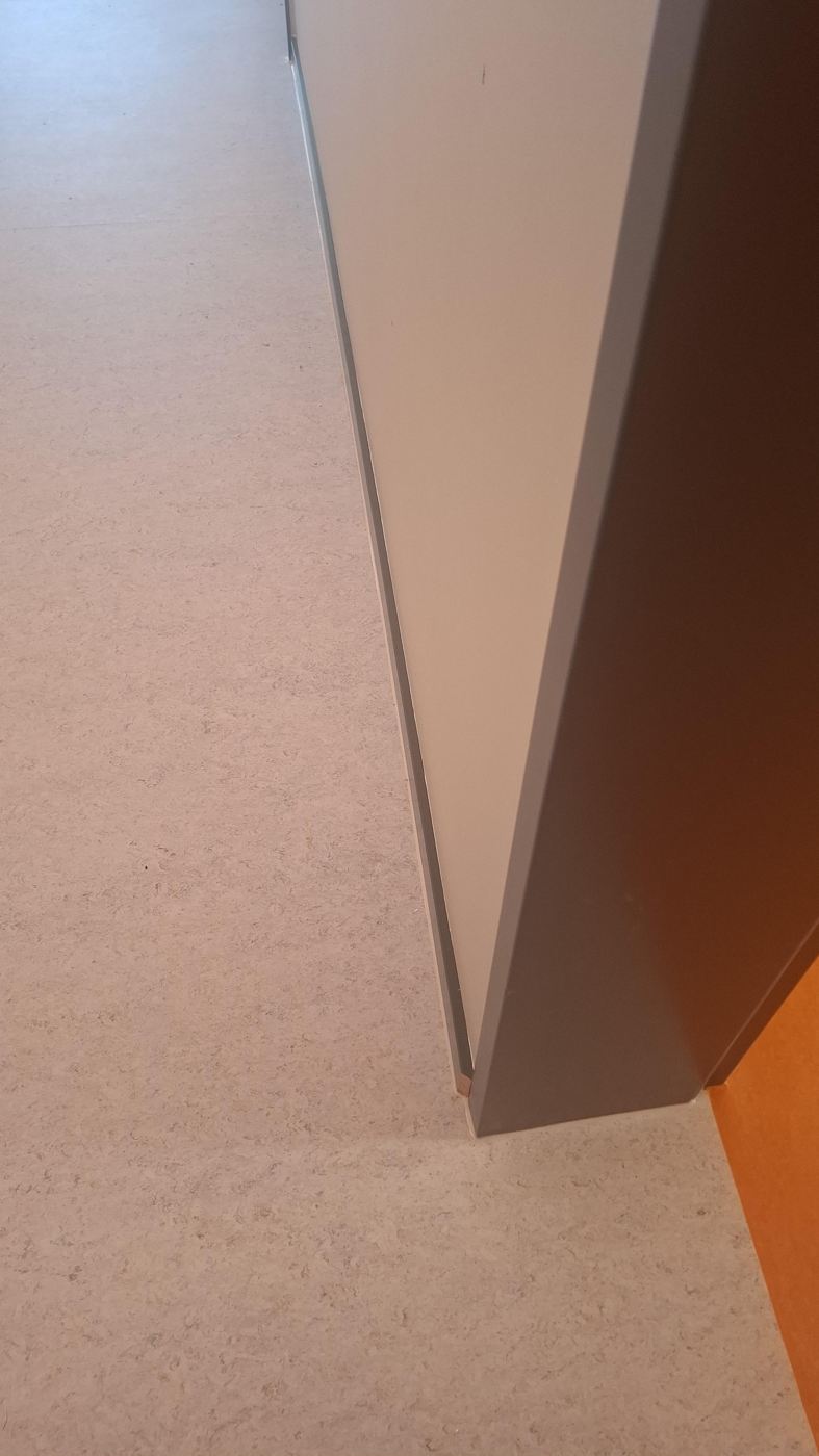 Finished school room with orange linoleum and black skirting