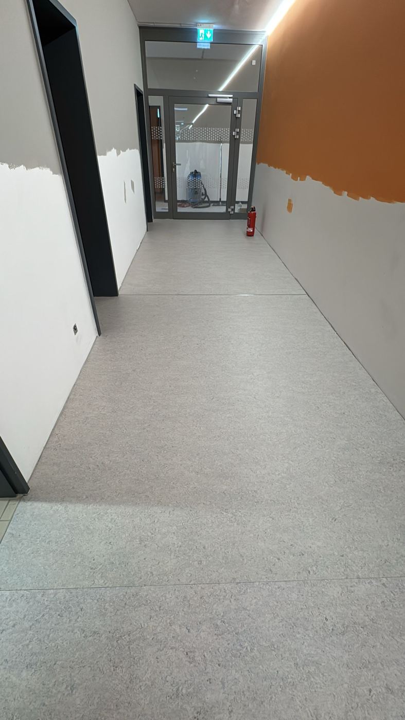 Finished school corridor with grey marbled linoleum