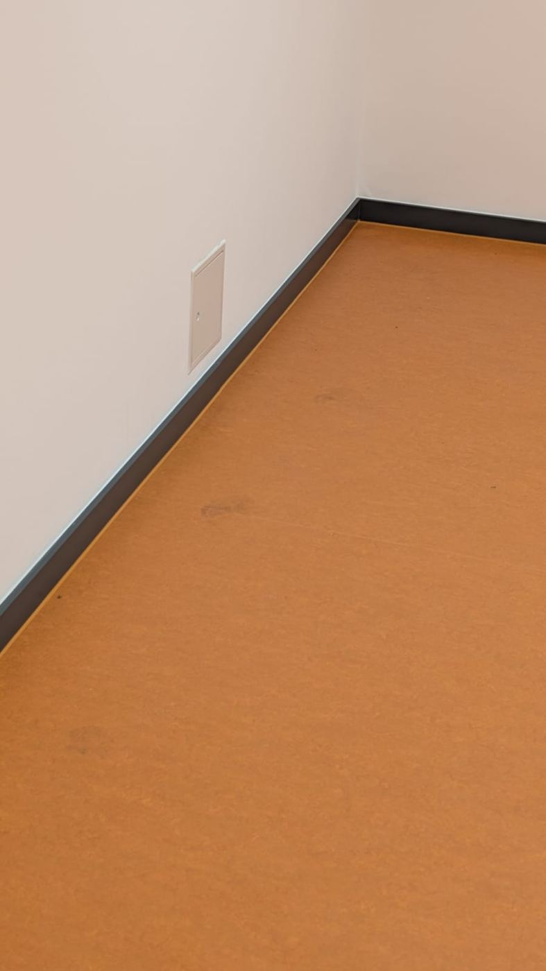 Close-up of linoleum neatly fitted around a door frame