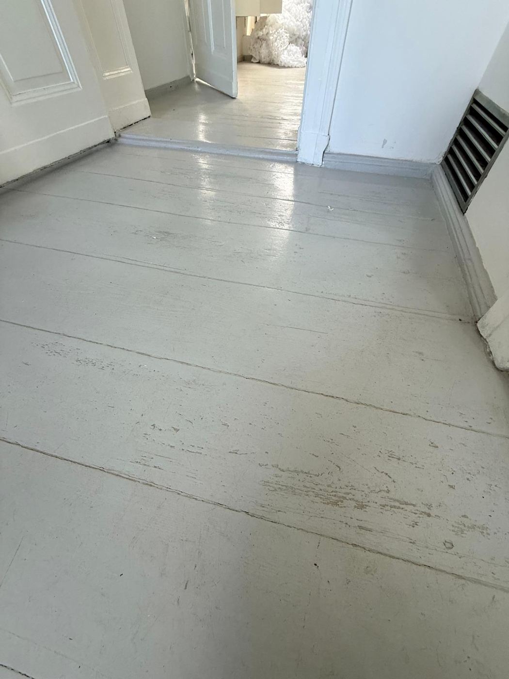 The same hallway with grey paint on the floorboards