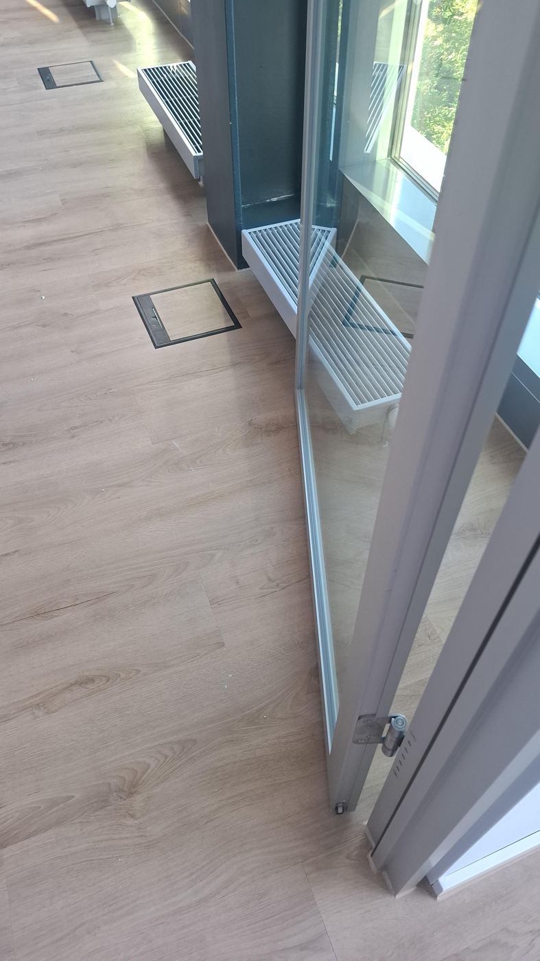 Design flooring fitted around glass folding wall floor tanks and convectors