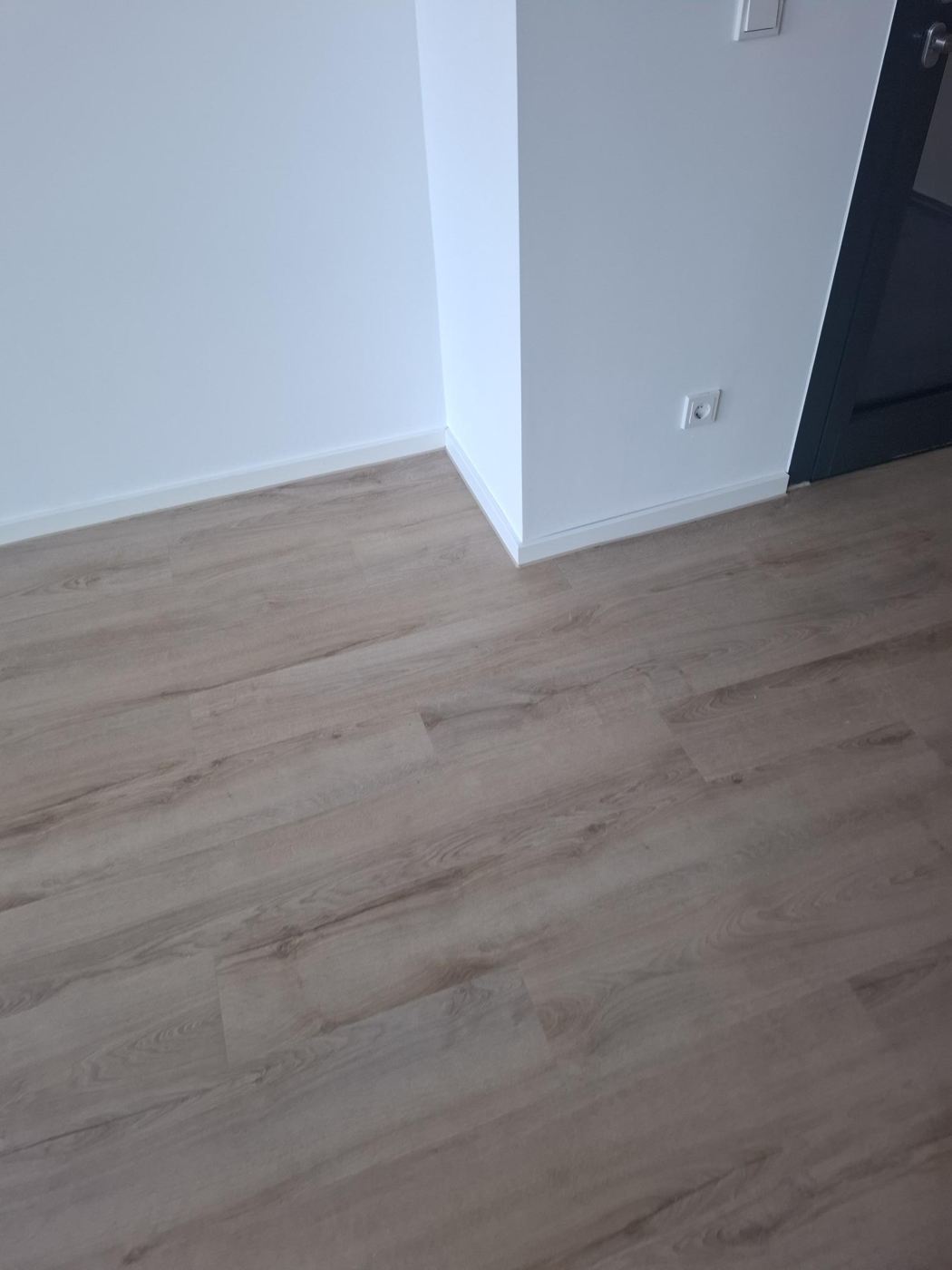 Design flooring with white skirting boards and clean door connection