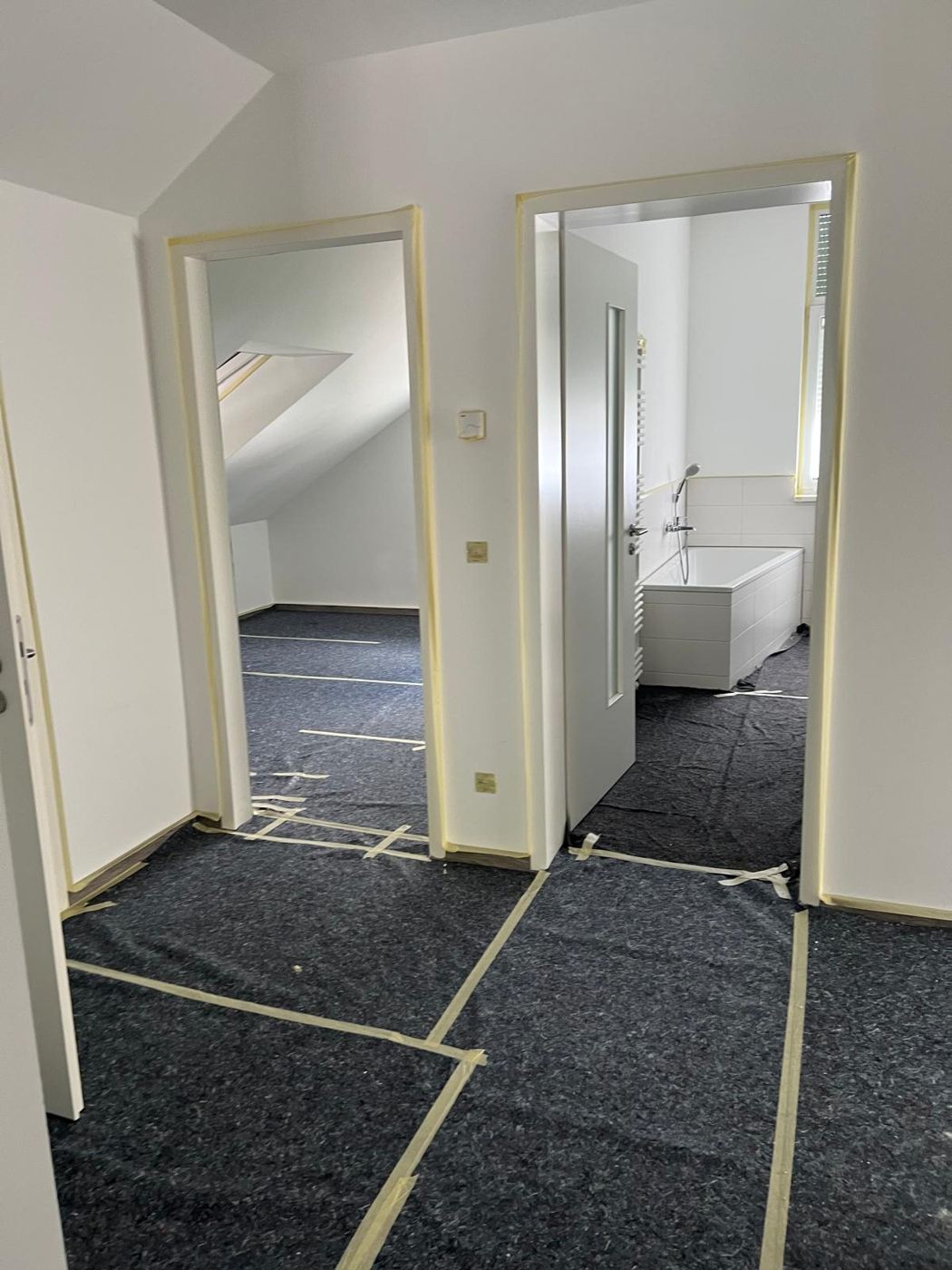 Freshly painted rooms with lacquered door frames and protected floor